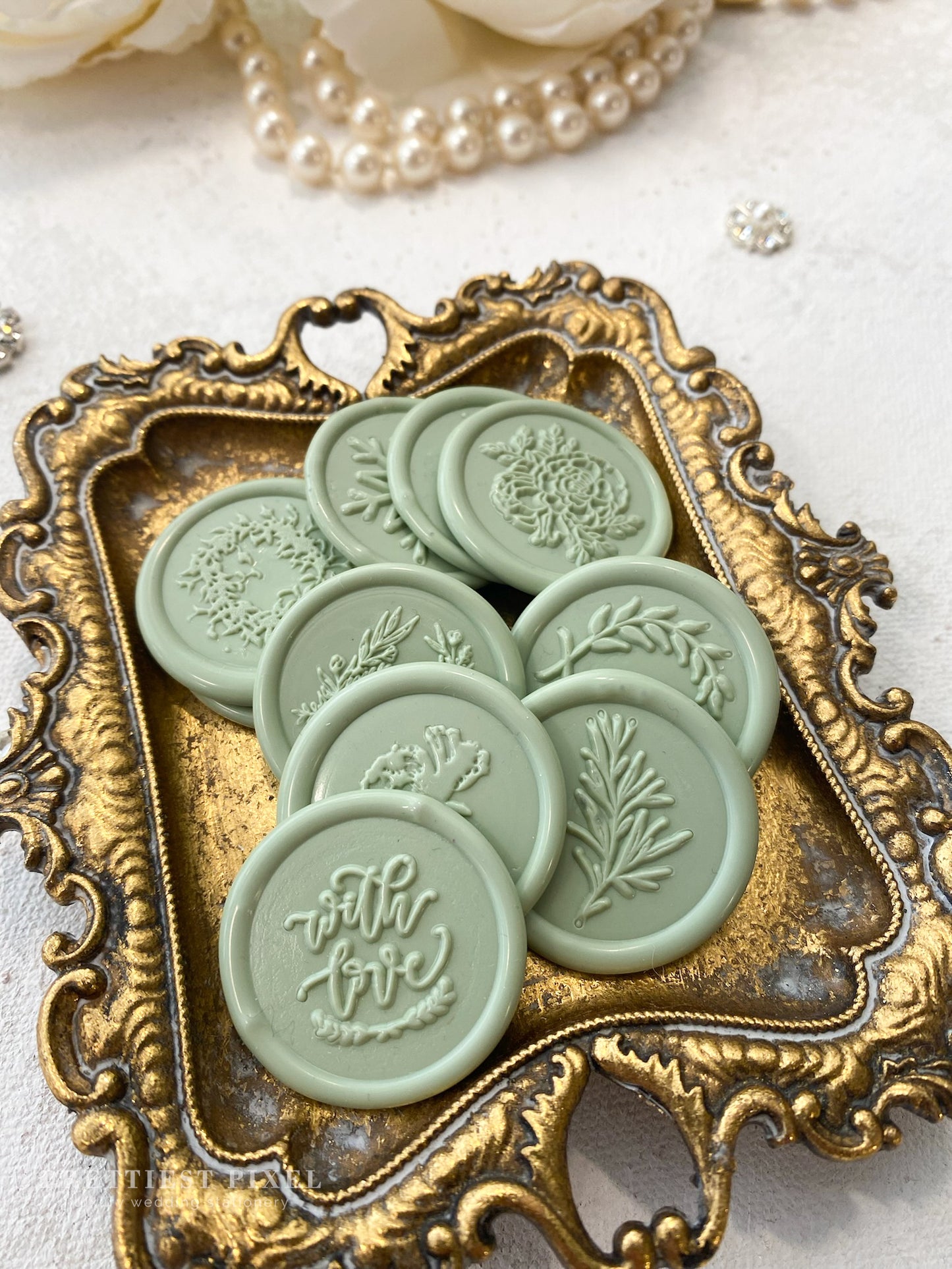 a tray with six wax seals sitting on top of a table