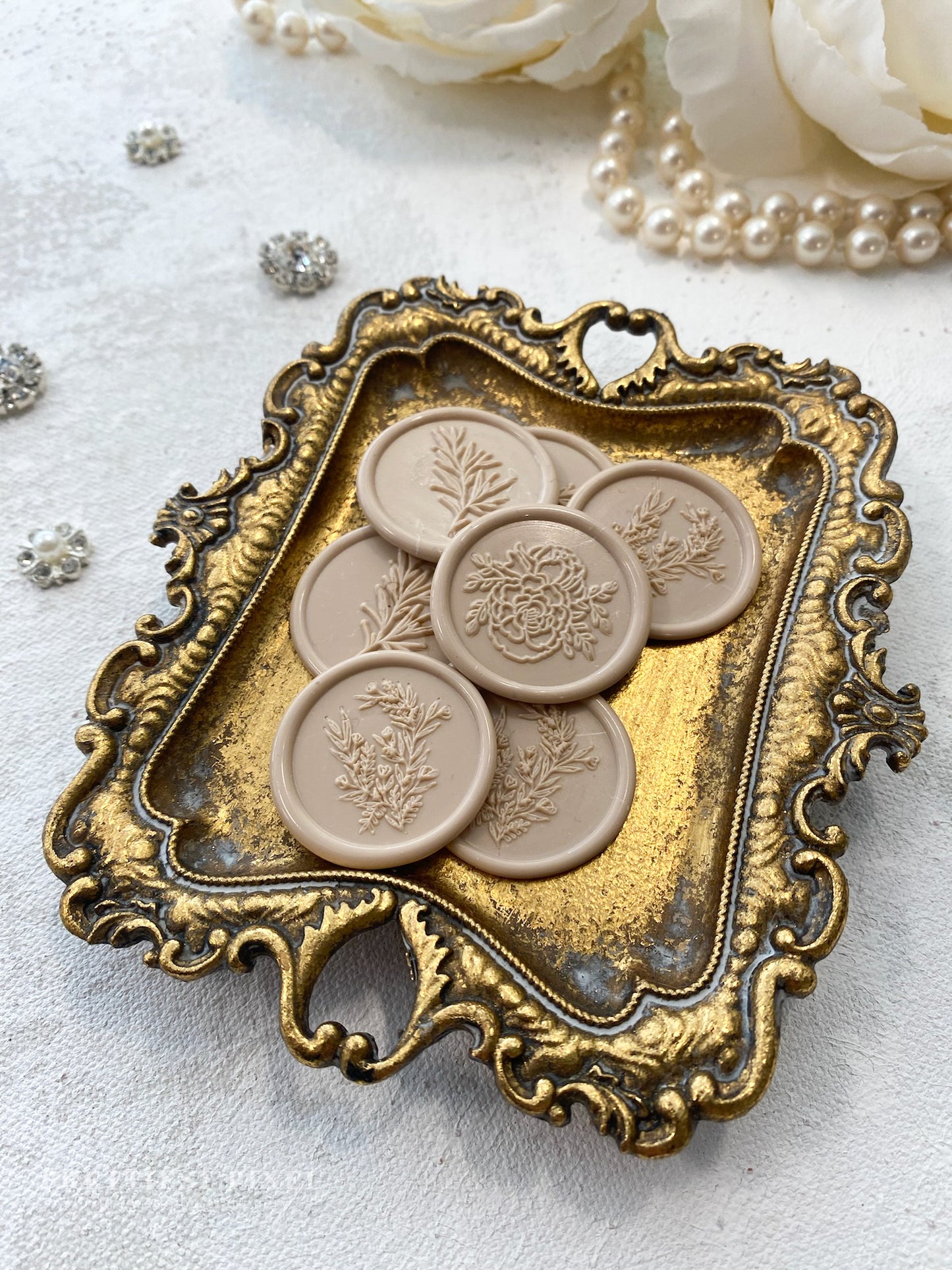 a decorative tray with four buttons on it