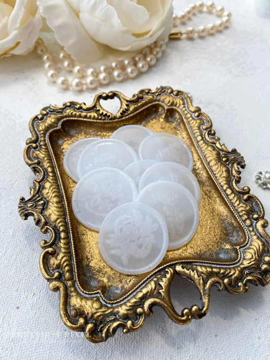 a close up of a tray of buttons on a table