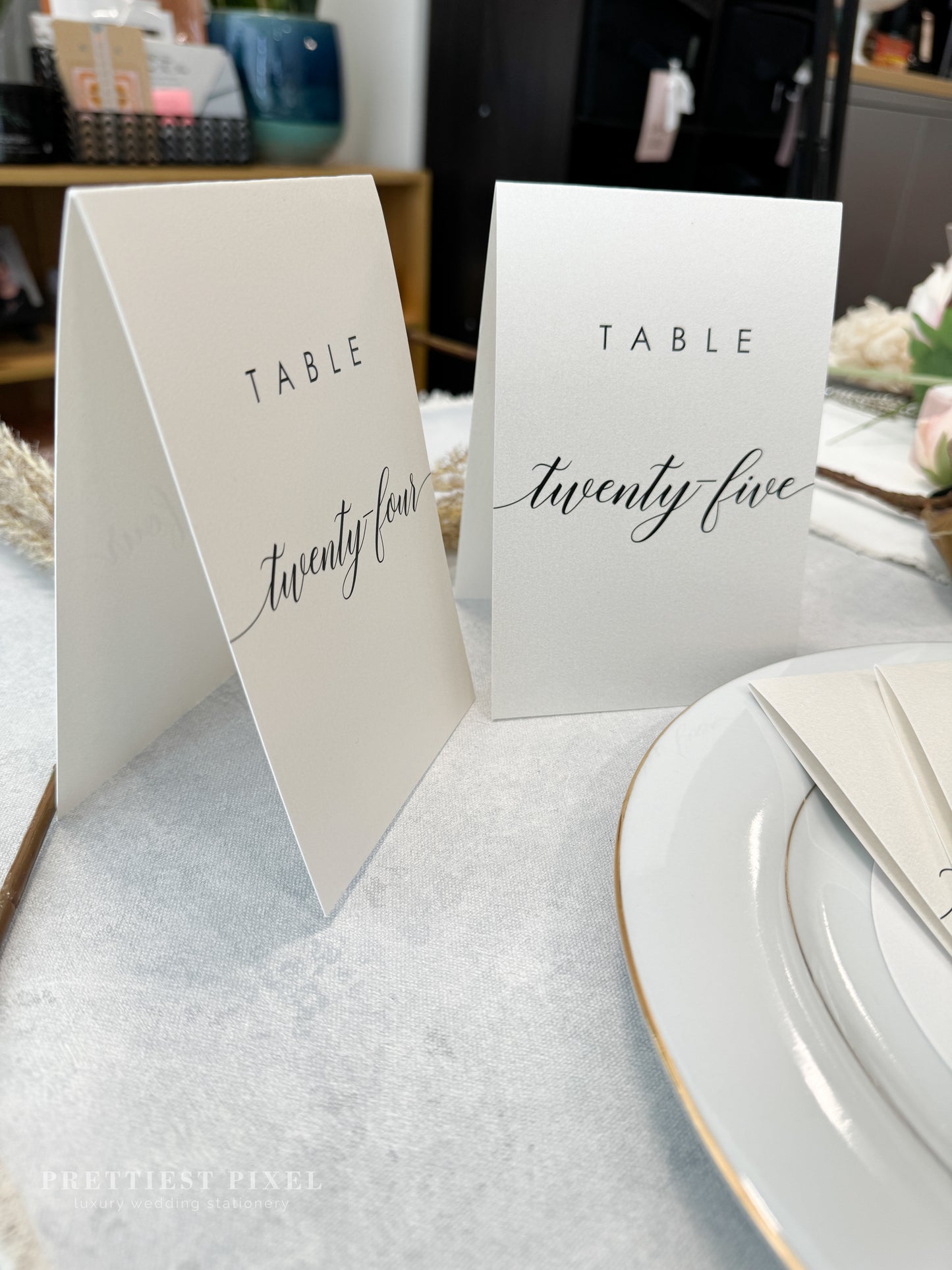 a table set with place cards and place settings