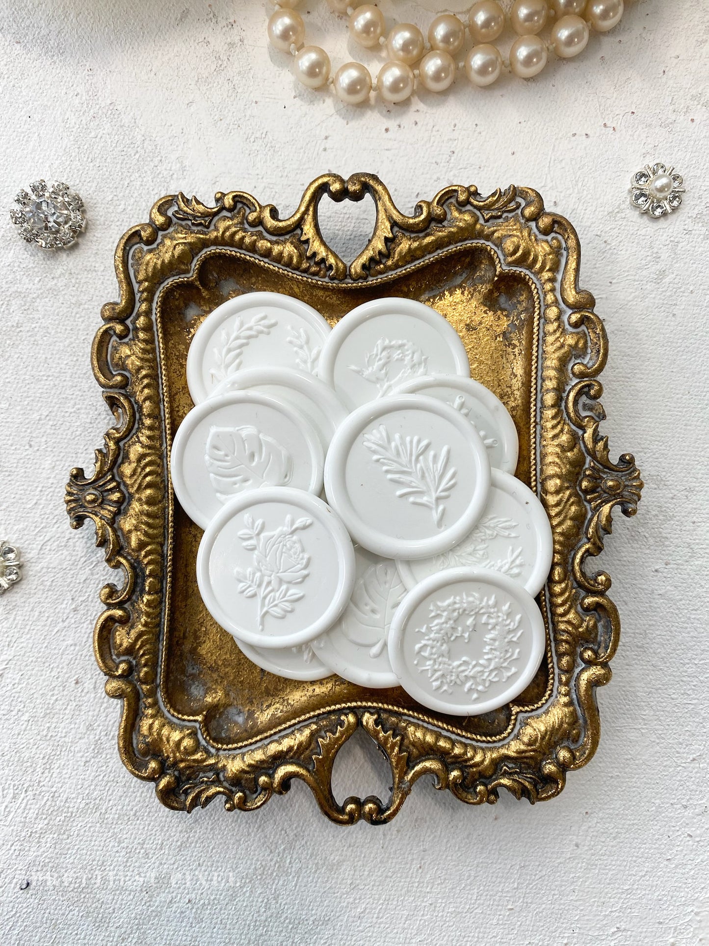 a picture of some white buttons in a gold frame