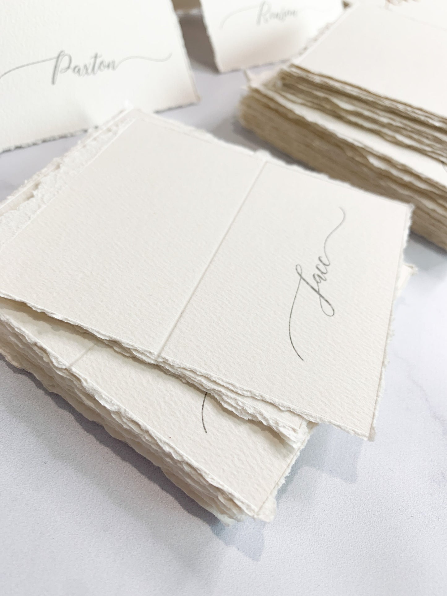 a table topped with lots of white cards