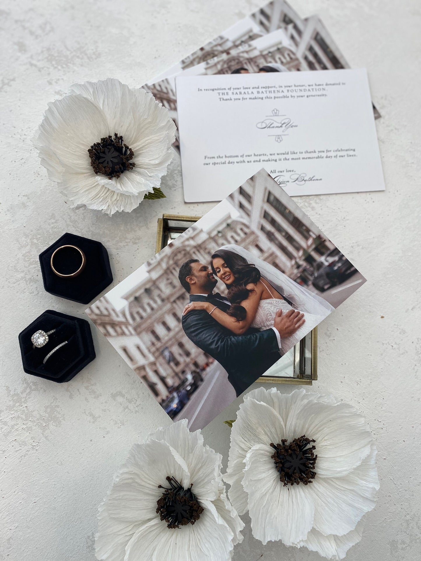 a picture of a bride and groom on a table with flowers