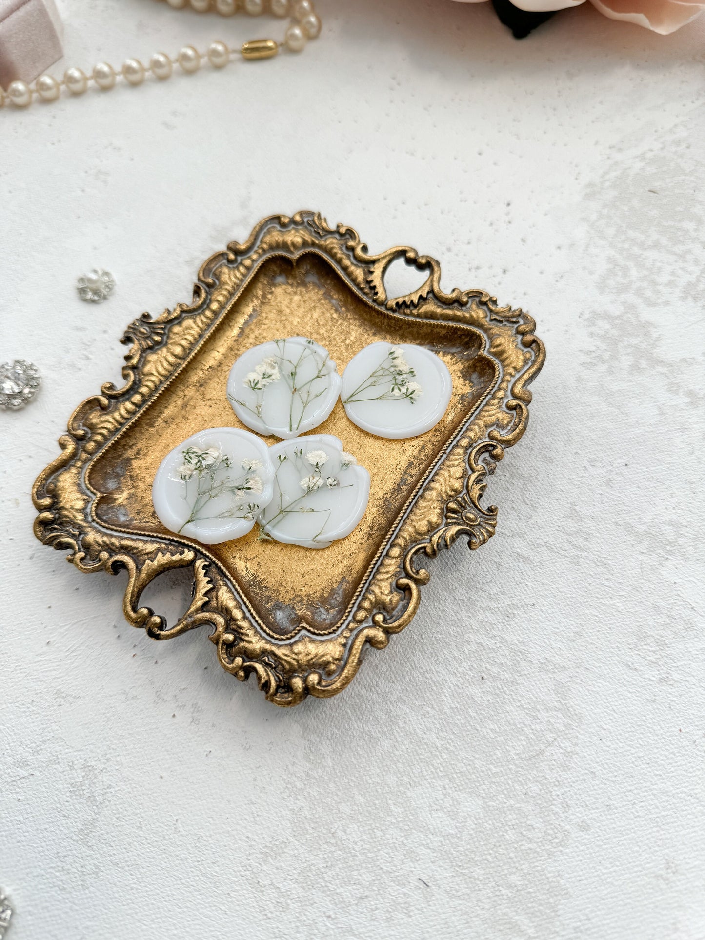 a picture of some white buttons in a gold frame