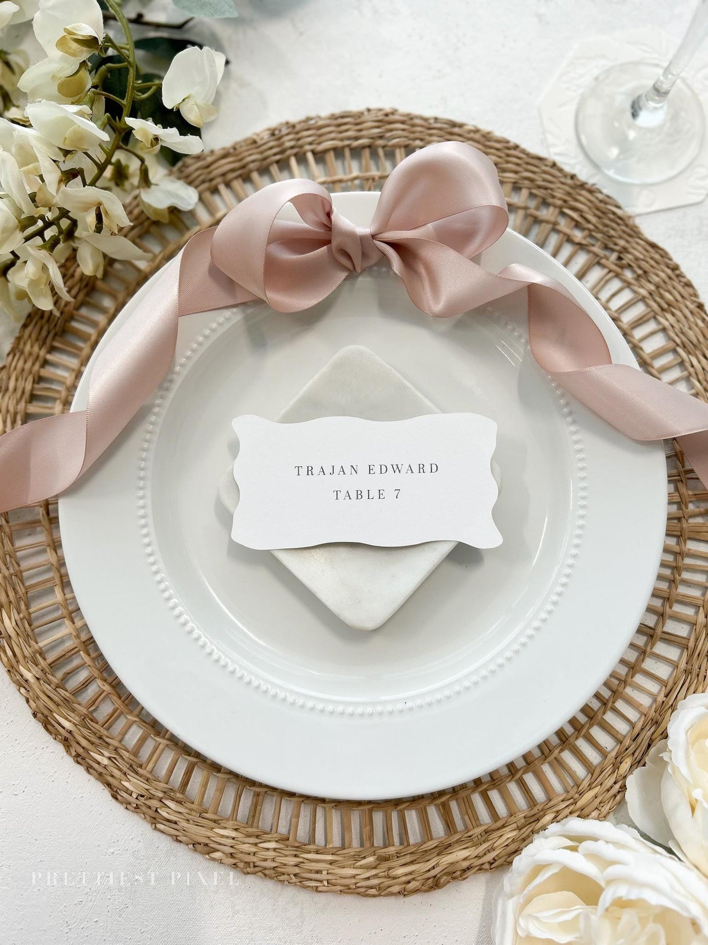 a place setting with a place card on a plate