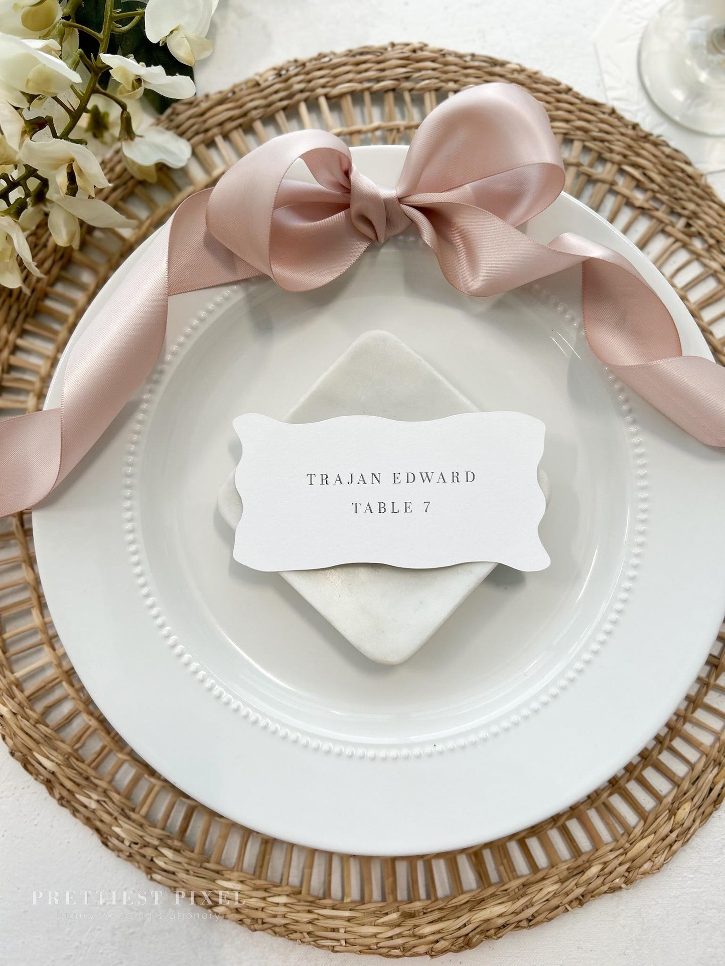 a place setting with a place card on a plate