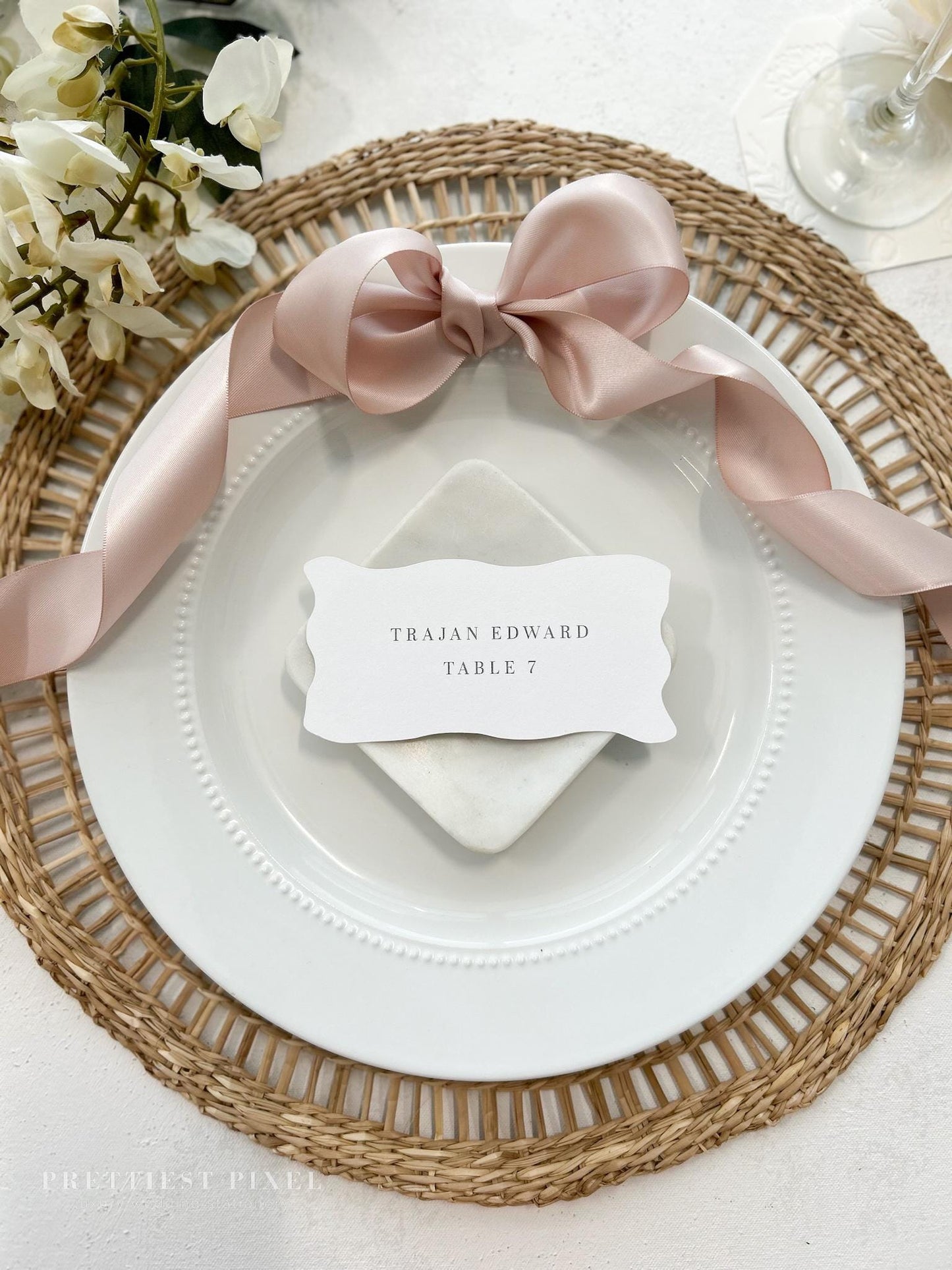 a place setting with a place card on a plate