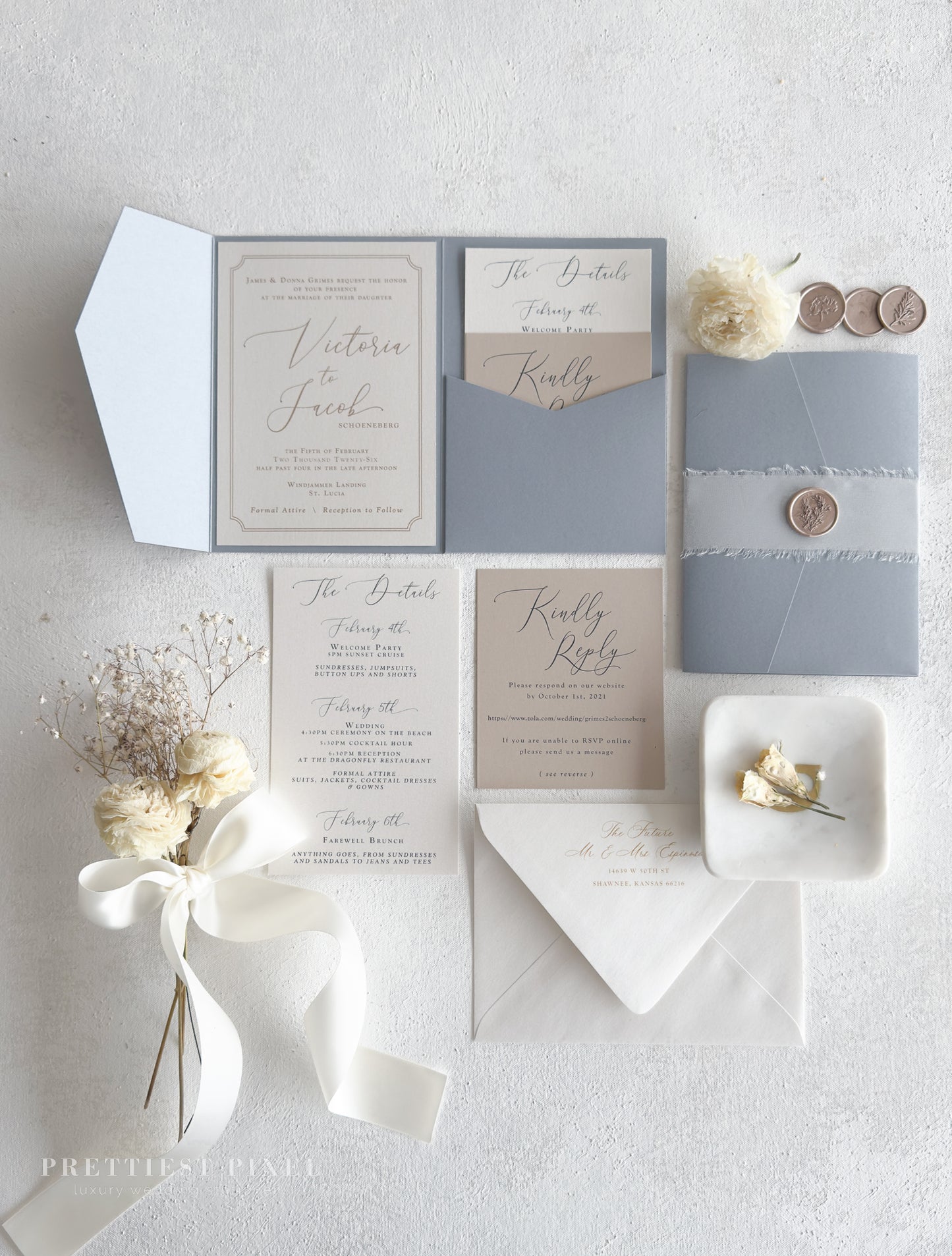 a collection of wedding-related items, including a wedding invitation, stationery, and decorative elements such as flowers and a ribbon.