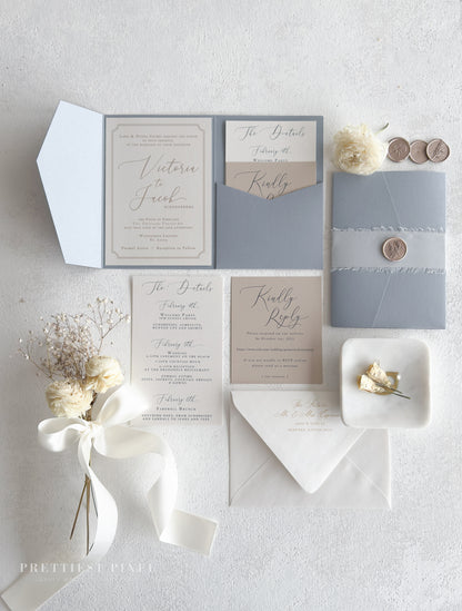 a collection of wedding-related items, including a wedding invitation, stationery, and decorative elements such as flowers and a ribbon.