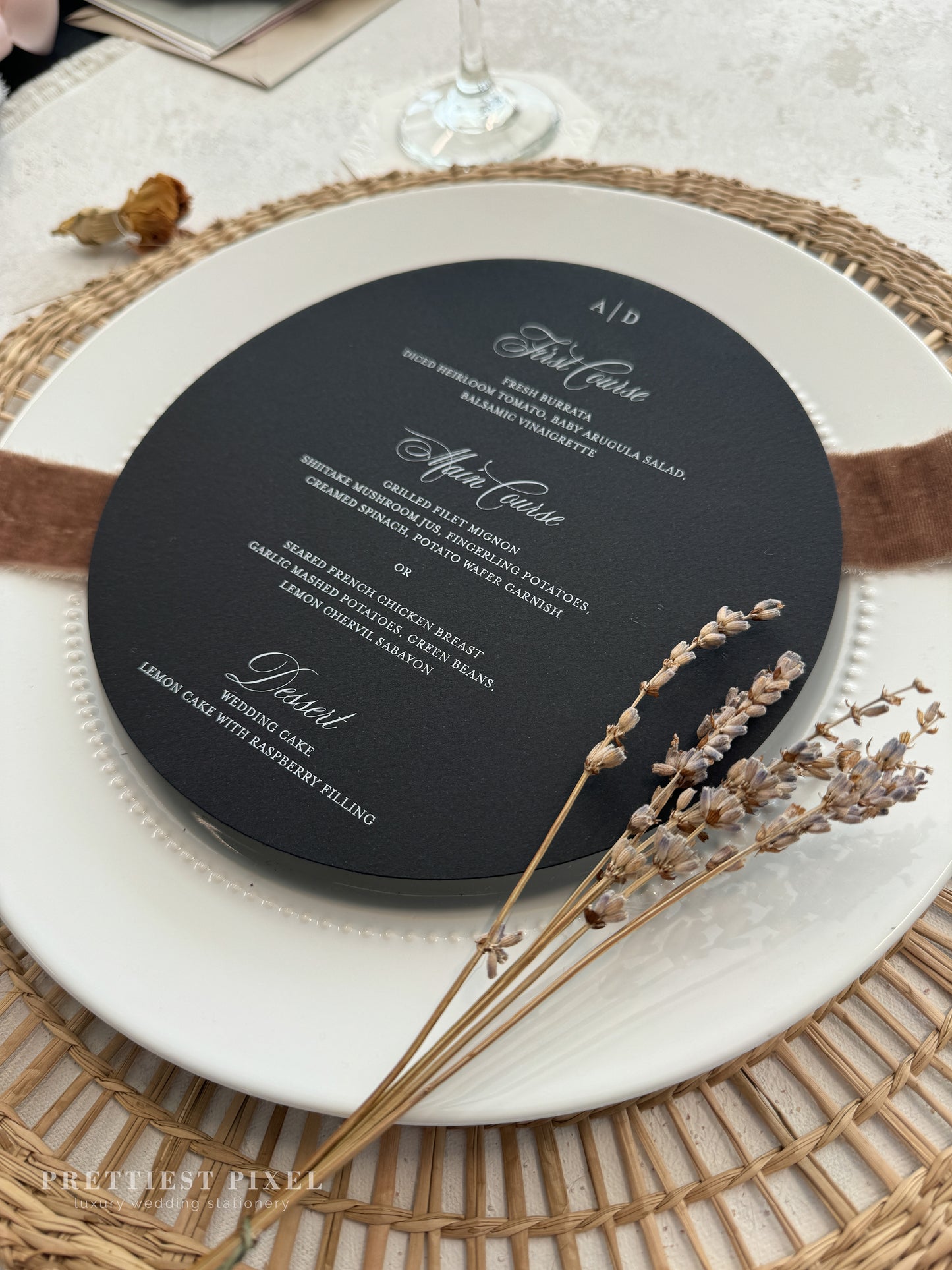 a black and white wedding menu on a white plate