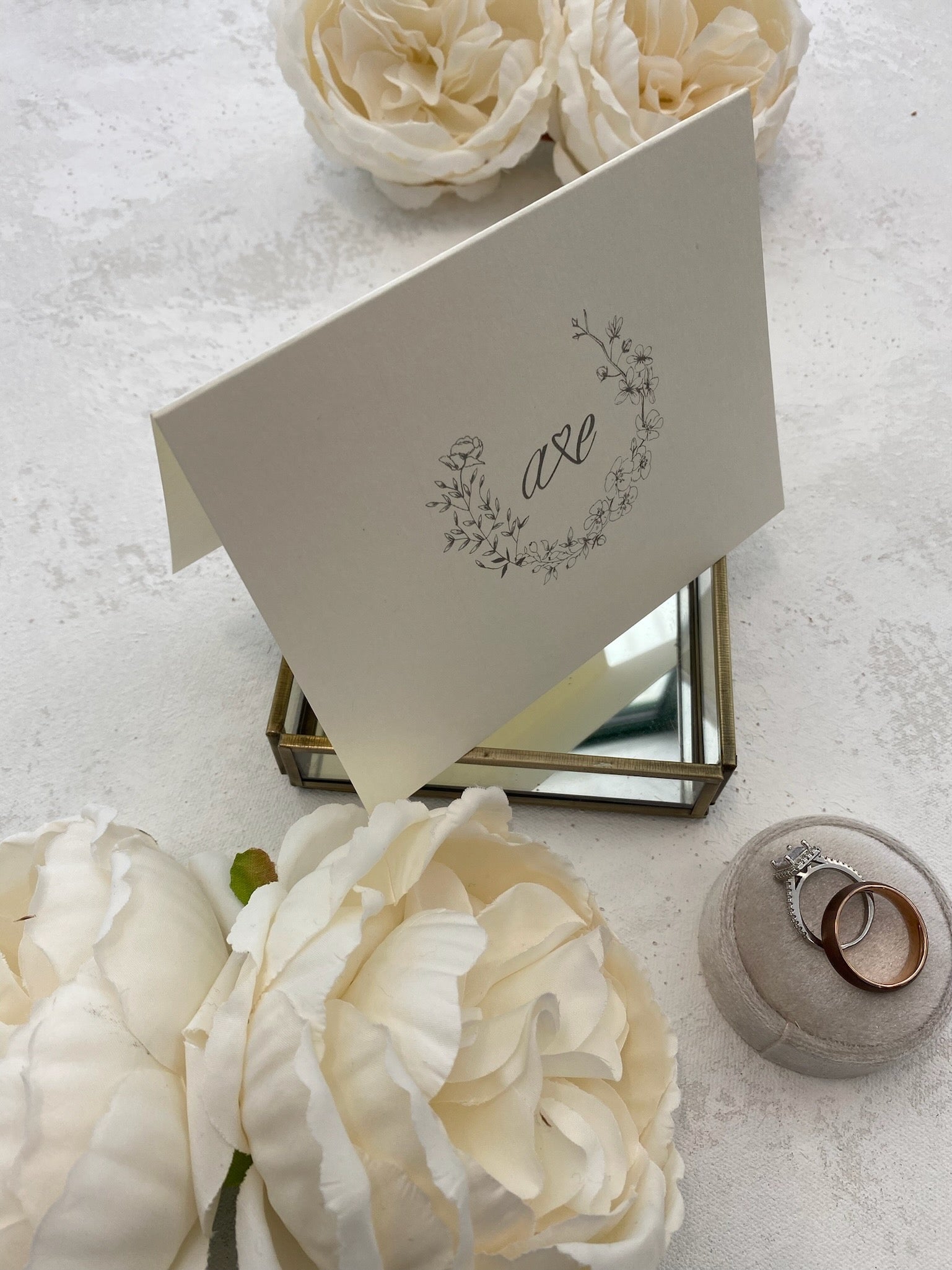 a table topped with white flowers and a card