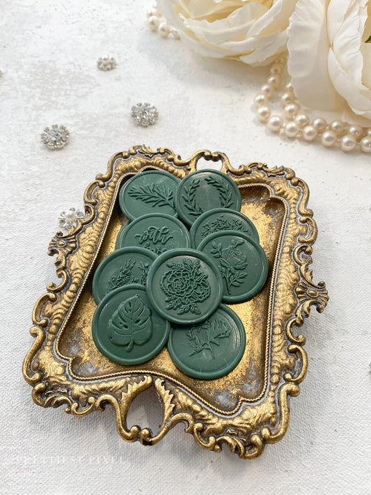 a close up of a brooch with flowers in the background