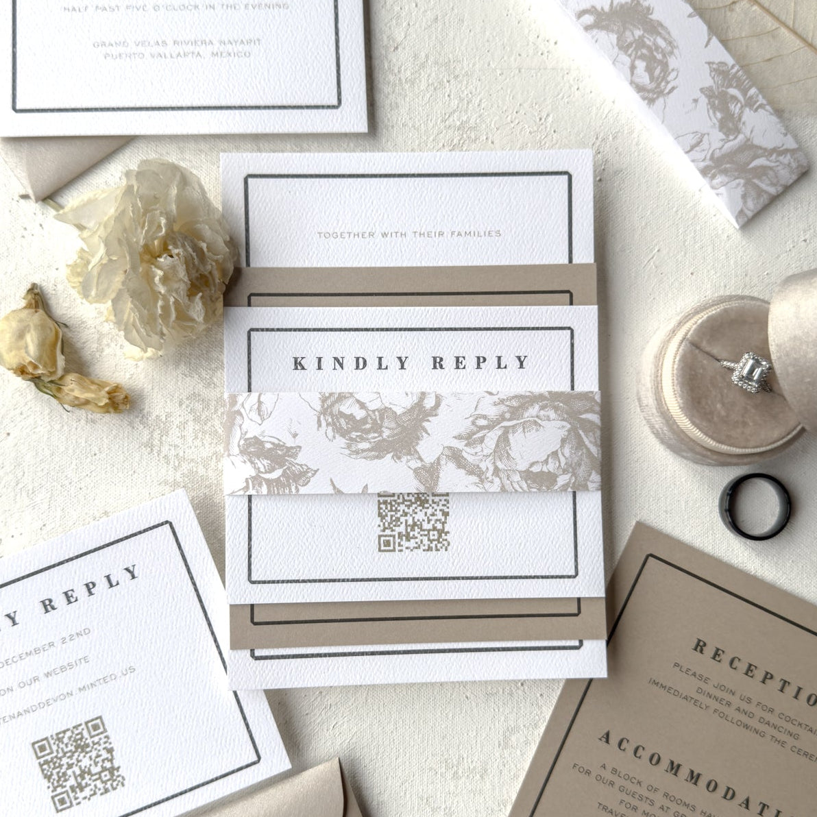 Wedding invitation set with RSVP card and details on a textured surface.