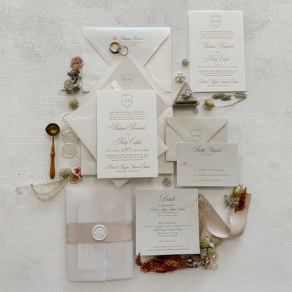 Collection of elegant wedding invitations and stationery on a textured surface