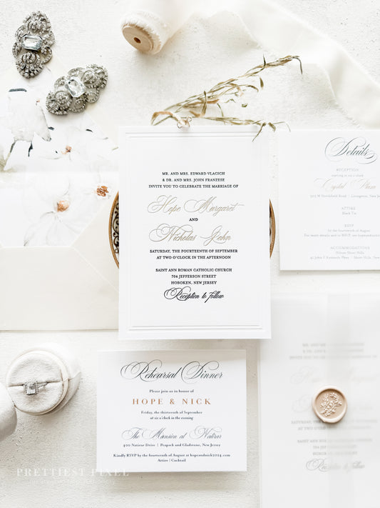Wedding invitation card with decorative elements on a white surface