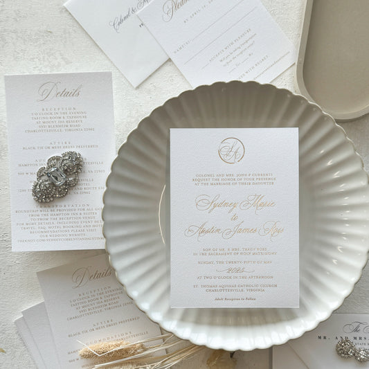 gold foil Wedding invitations set with decorative elements on a light surface
