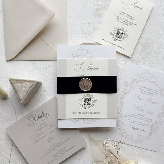 Elegant wedding invitation set with envelope, card, and decorative elements on a light background.