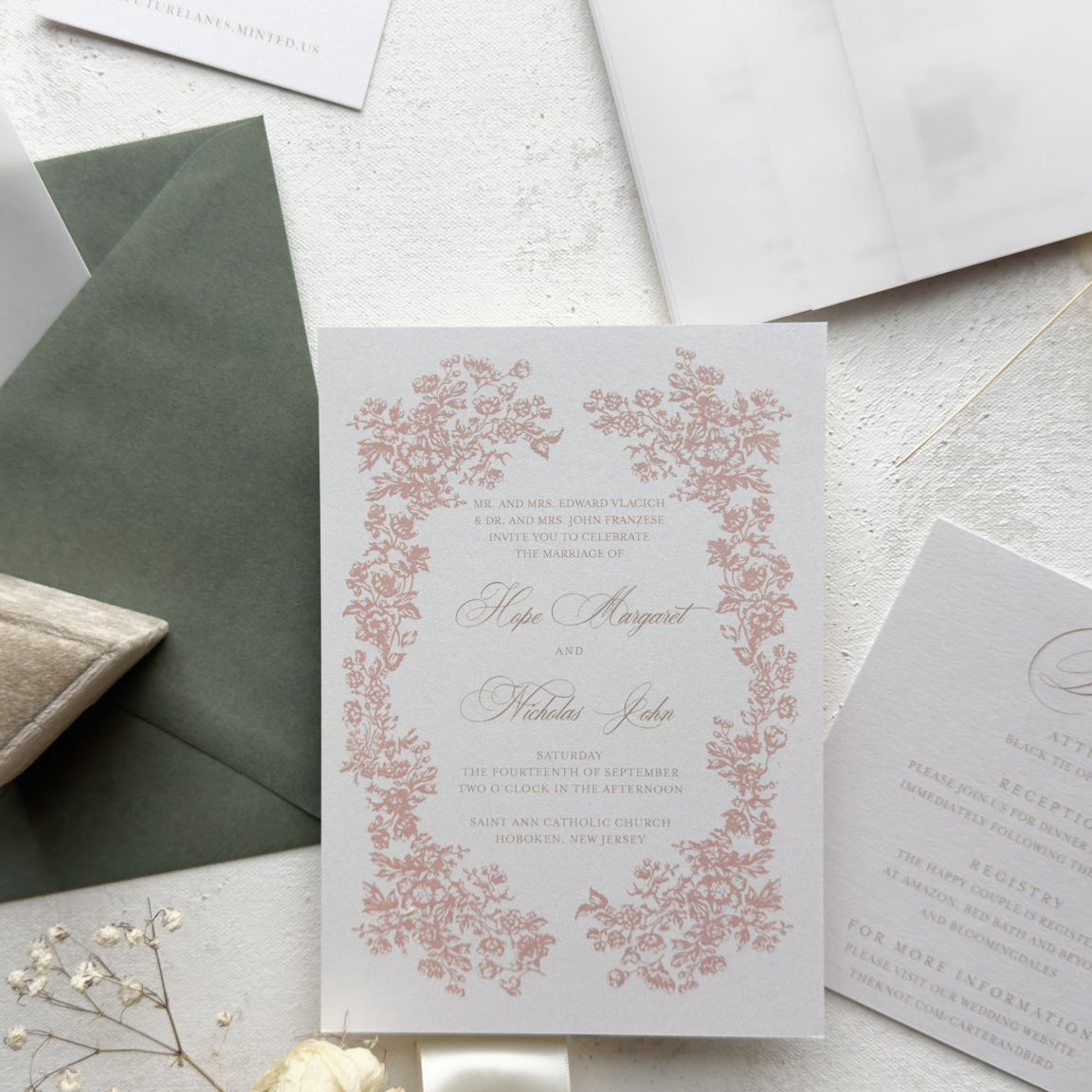Wedding invitation card with floral design on a light surface