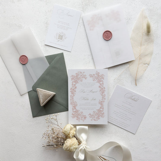 Stationery items including envelopes, cards, and a ribbon on a light background