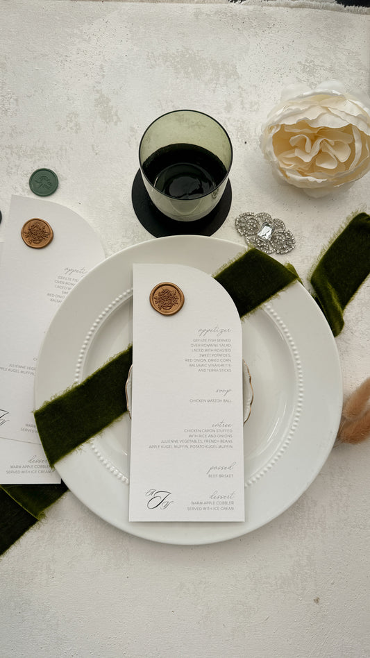a white plate with a green ribbon around it