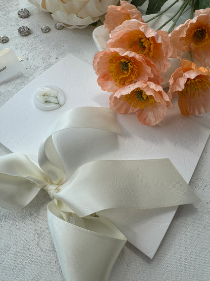 a bouquet of flowers sitting next to a piece of paper