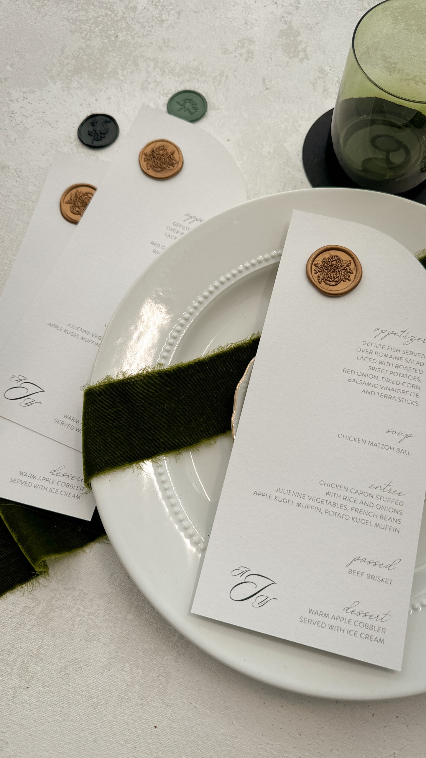 a white plate topped with a green ribbon