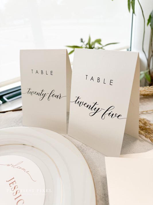 a table setting with place cards and place cards