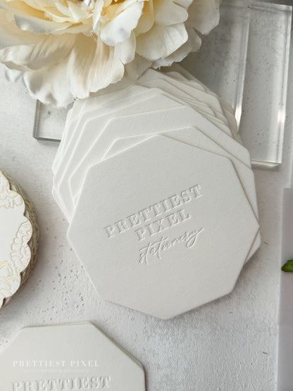 a white table topped with white plates and flowers