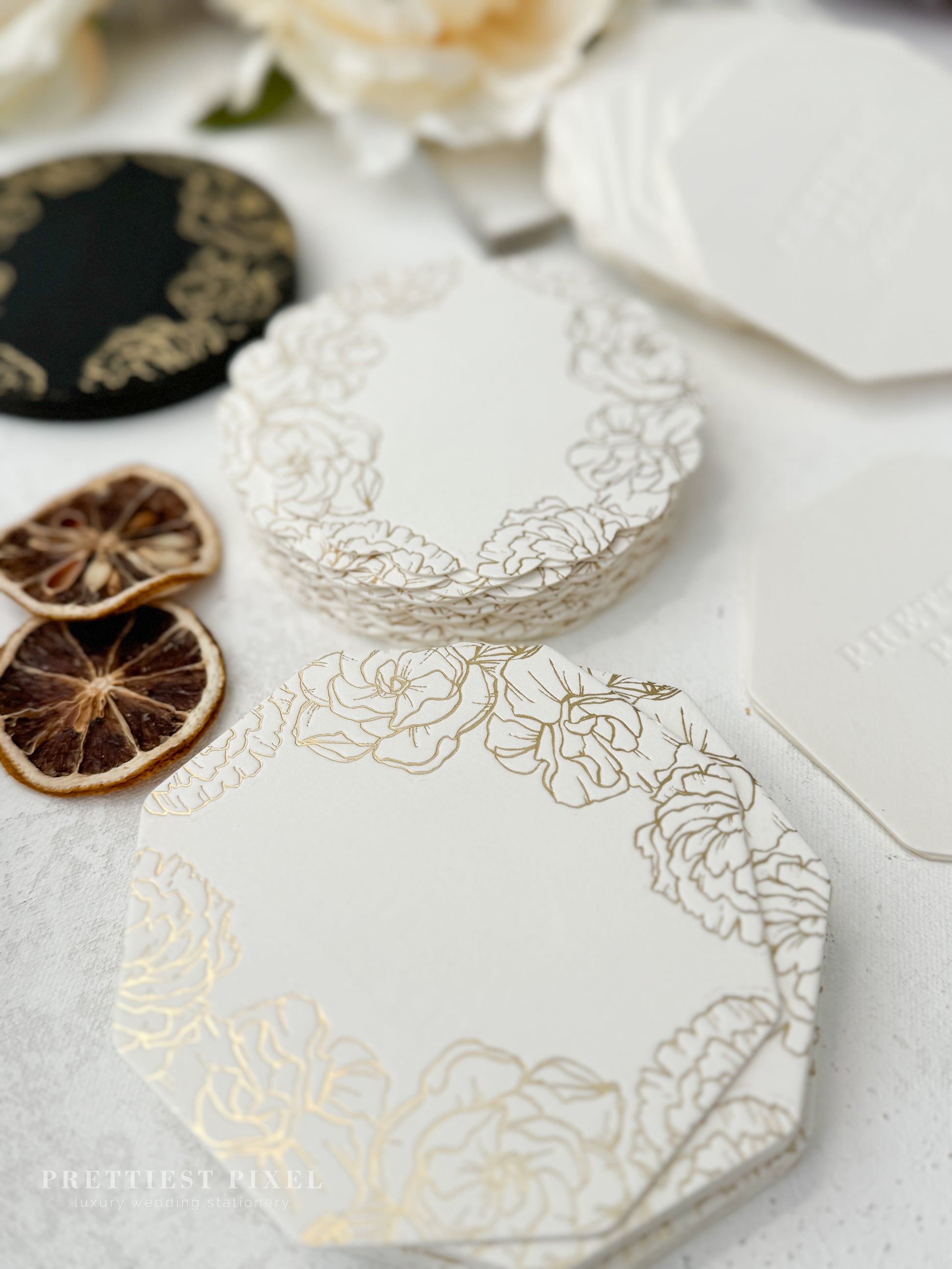 a table topped with white and gold plates