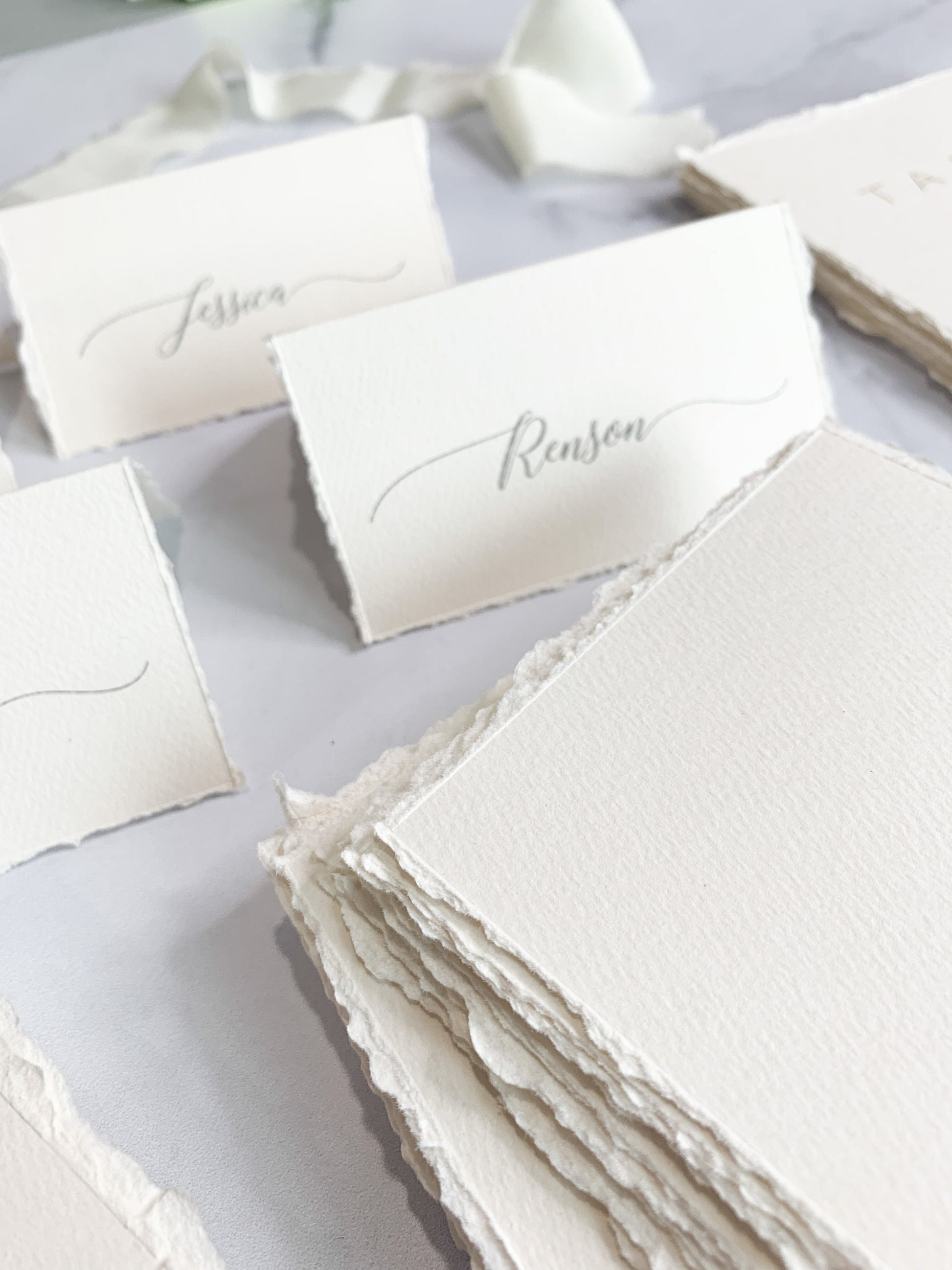 a table topped with lots of white cards