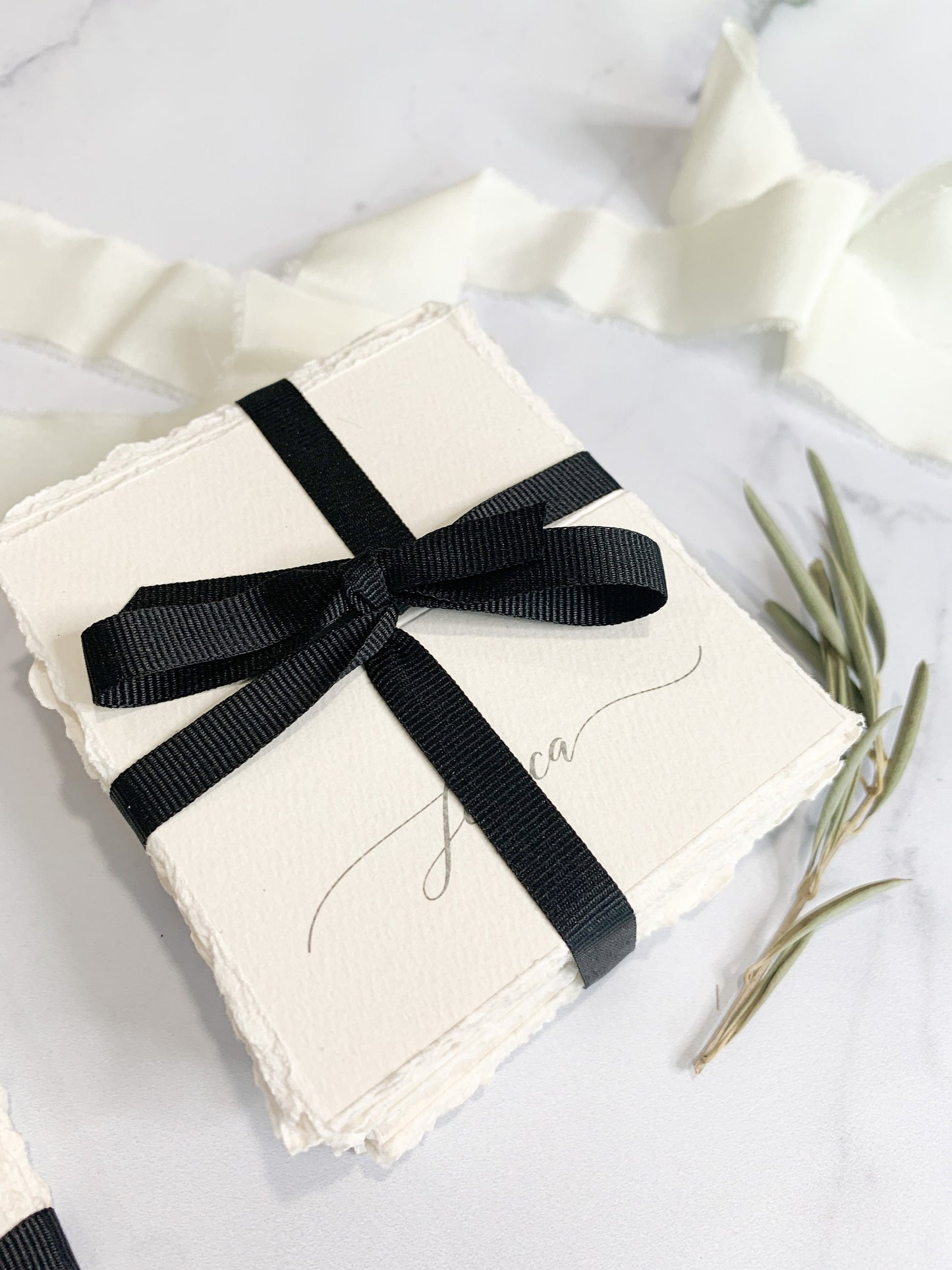 a black and white wedding card with a bow