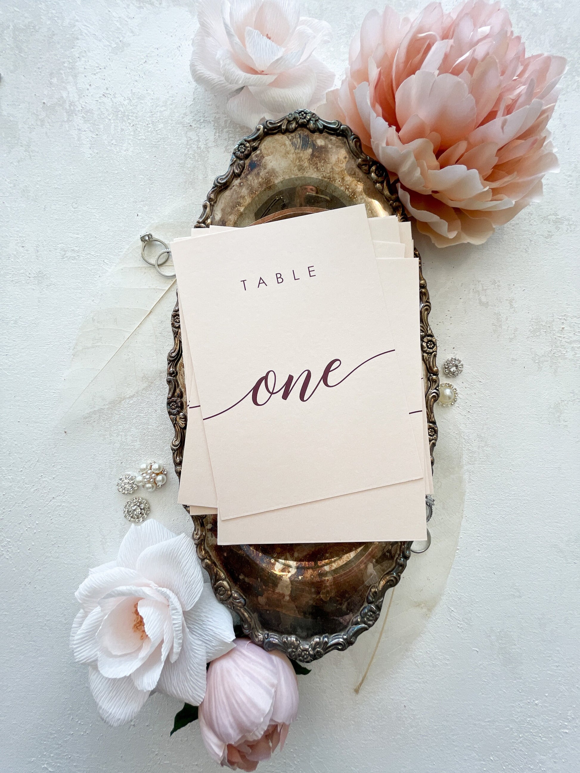 a table sign sitting on top of a table next to flowers