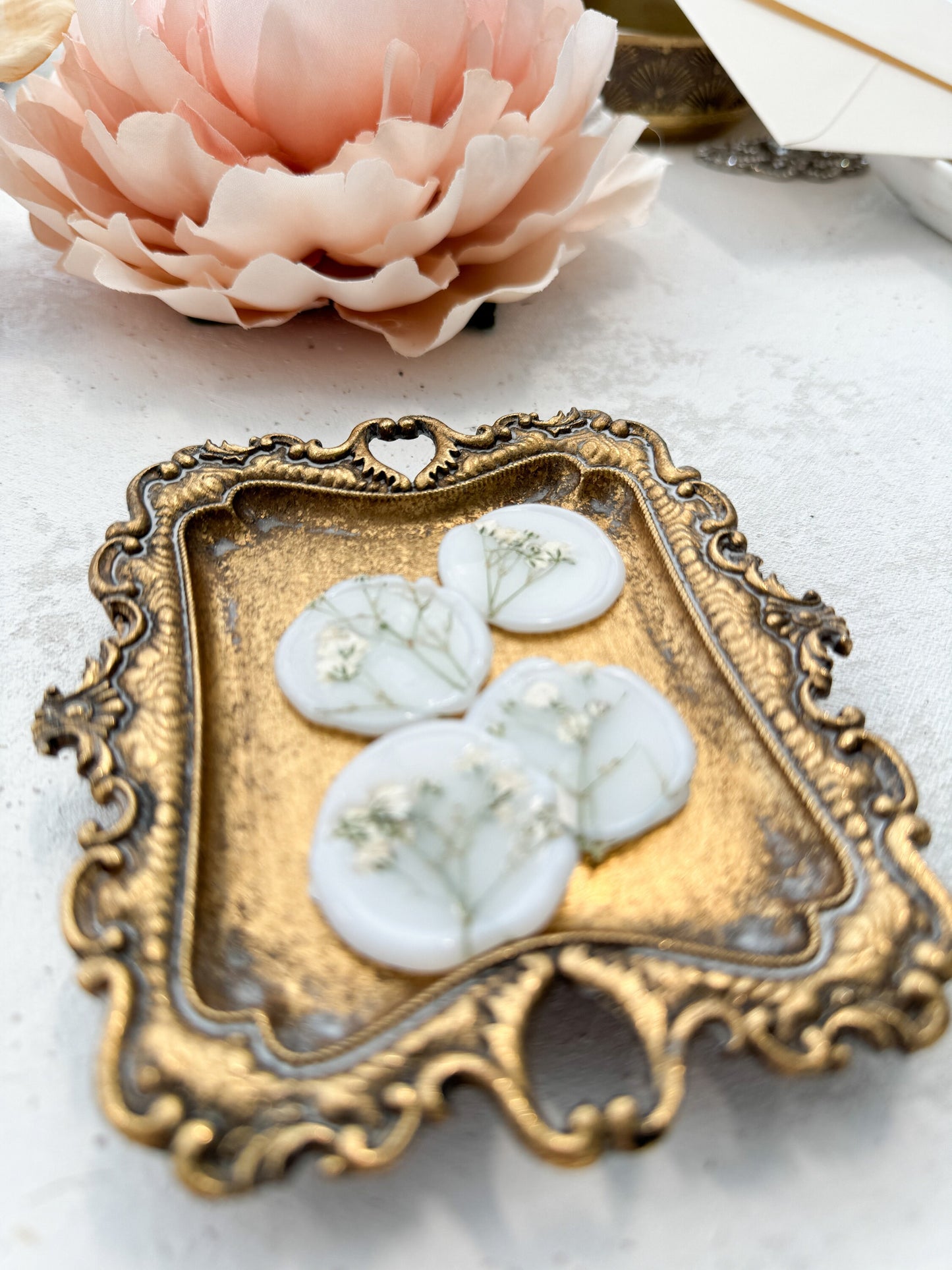 a flower and a decorative tray on a table