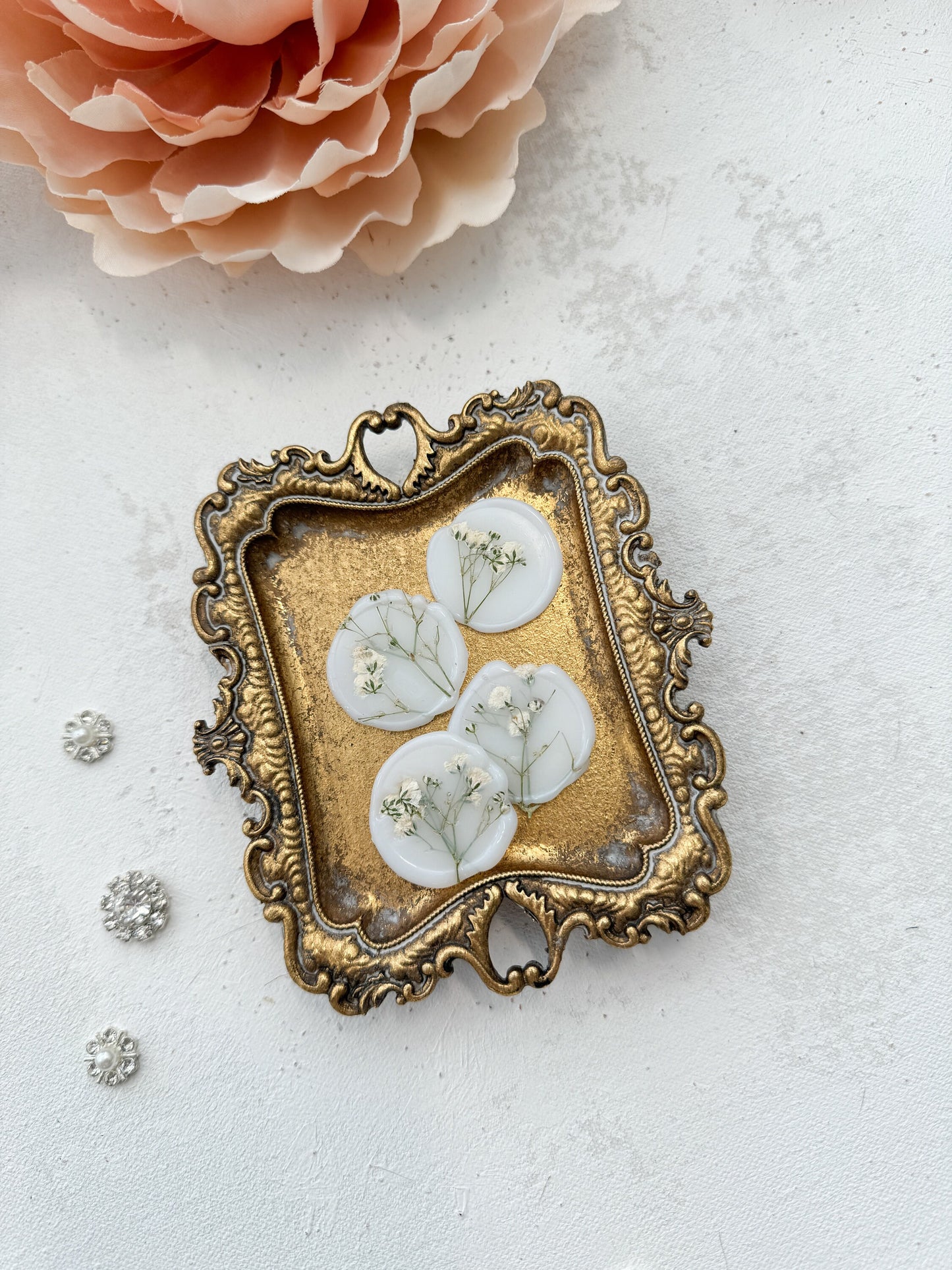 a picture frame with three white flowers on it